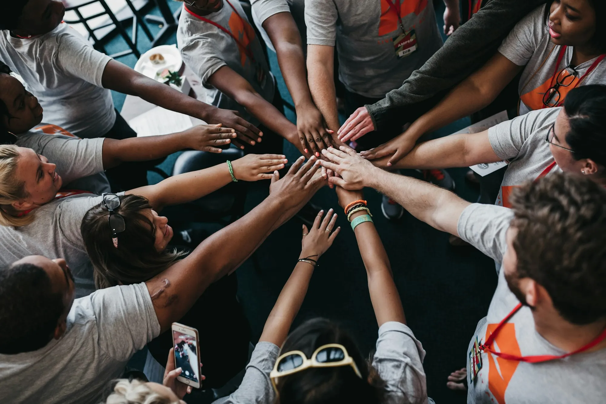 Volunteers joining hands in a circle